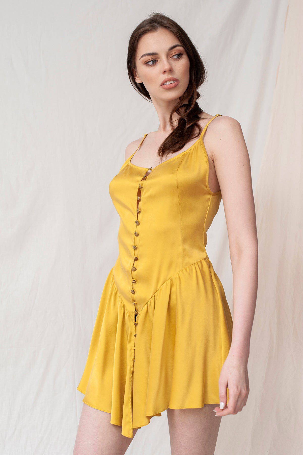 Gold sleeveless mini dress with front buttons, sustainable and handmade organic fabric, eco-friendly and ethical design.