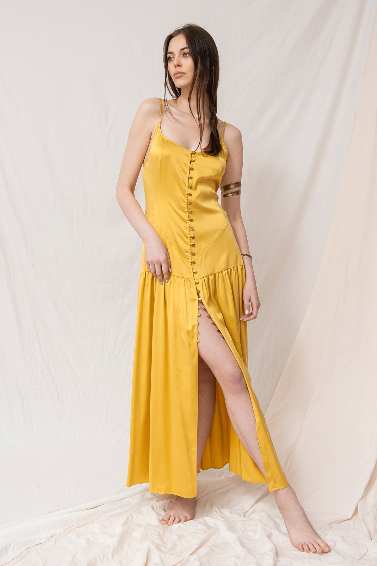 Gold Celina maxi dress with front buttons and thigh-high slit, sustainable, handmade, eco-friendly organic fabric.
