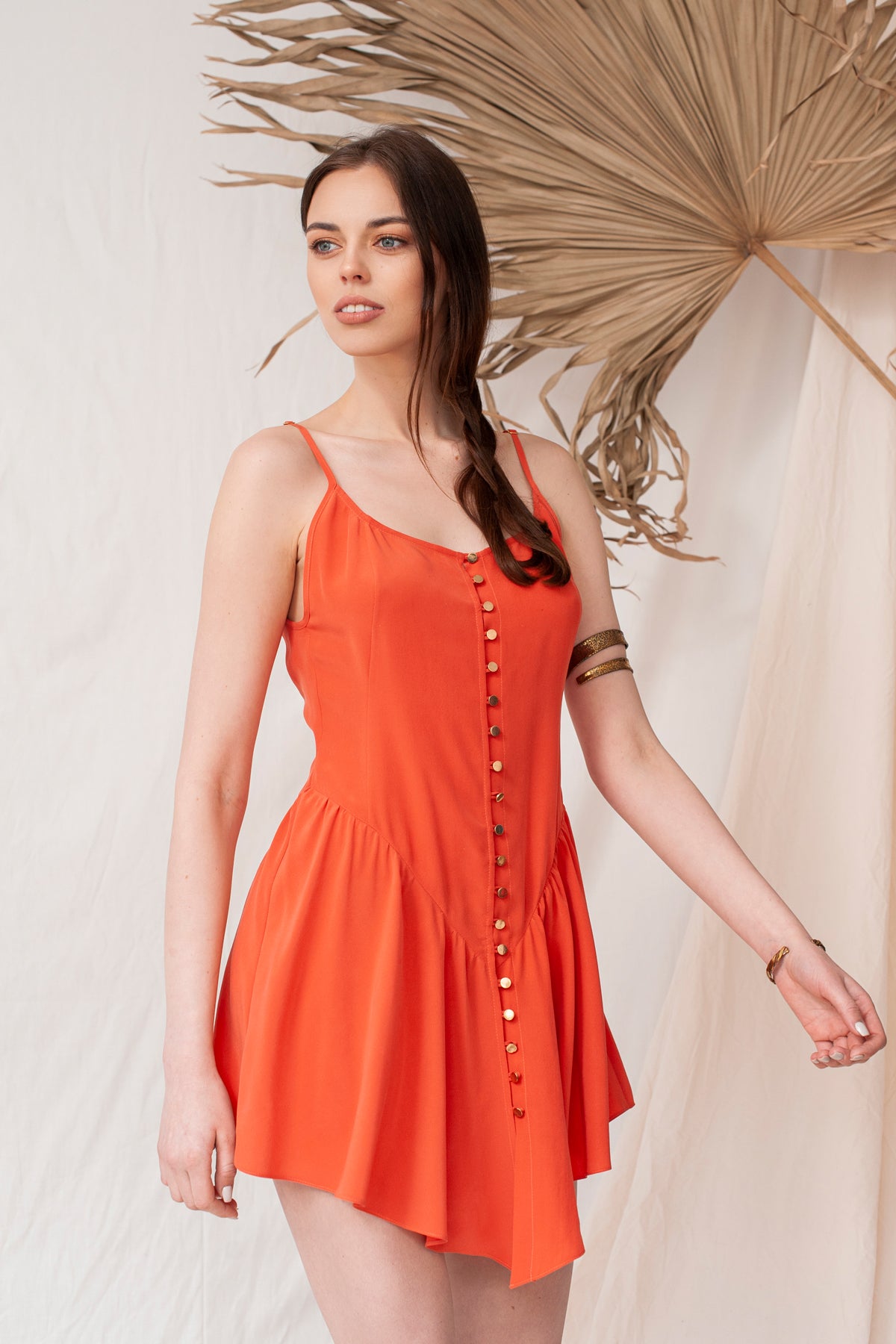 Coral mini dress with thin straps, button-down front, and flowy skirt, sustainable and handmade organic fabric.
