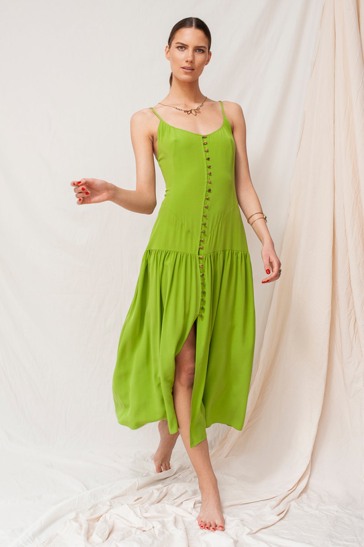 Sustainable green maxi dress with spaghetti straps and front buttons, handmade organic fabric, eco-friendly and ethical.
