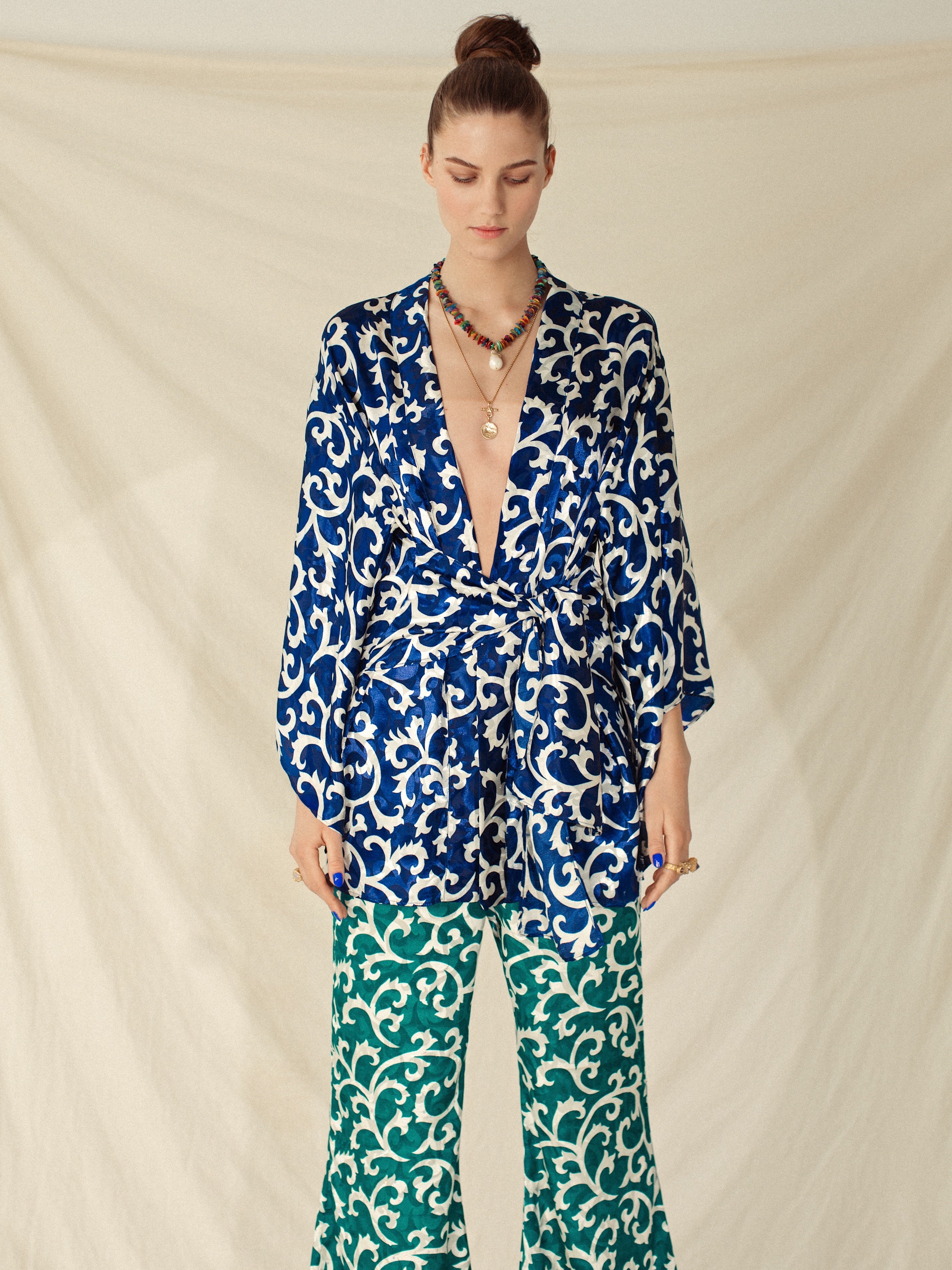 Blue sapphire kimono with white intricate swirl patterns, handmade sustainable fabric, paired with eco-friendly green.