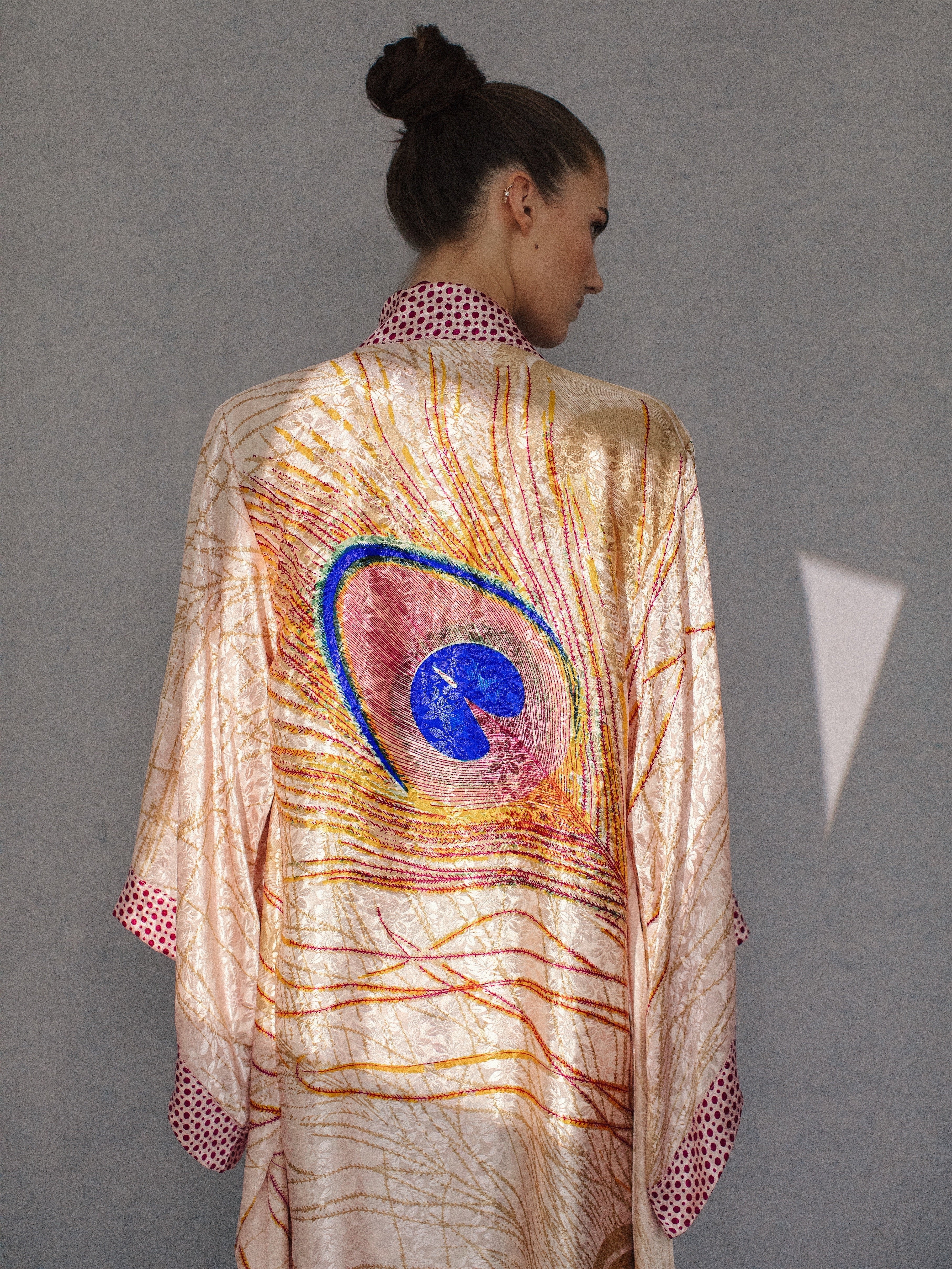 Magenta sustainable handmade kimono with large organic peacock feather design and eco-friendly ethical fabric.