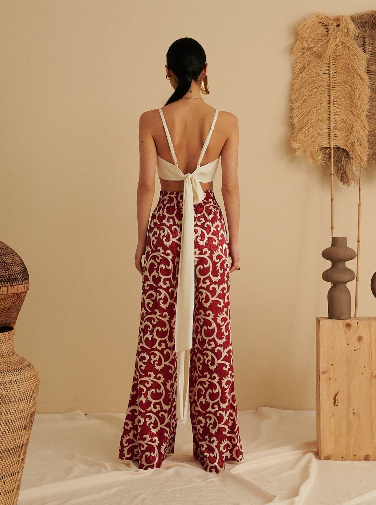 Red ruby flared trousers with white floral pattern, sustainable and handmade organic fabric.