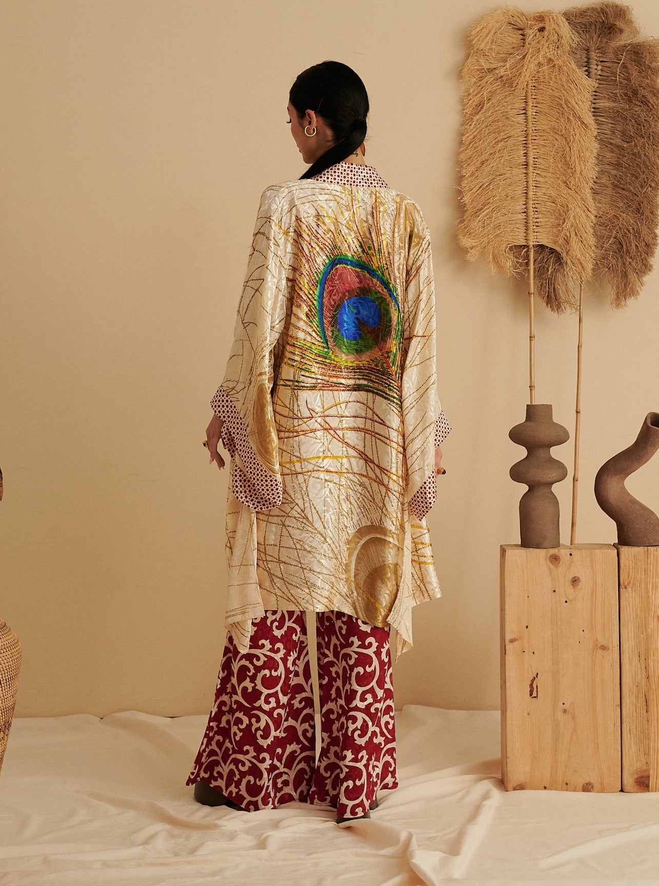 Ruby red sustainable kimono with vibrant peacock feather design, handmade organic fabric, ethical fashion.