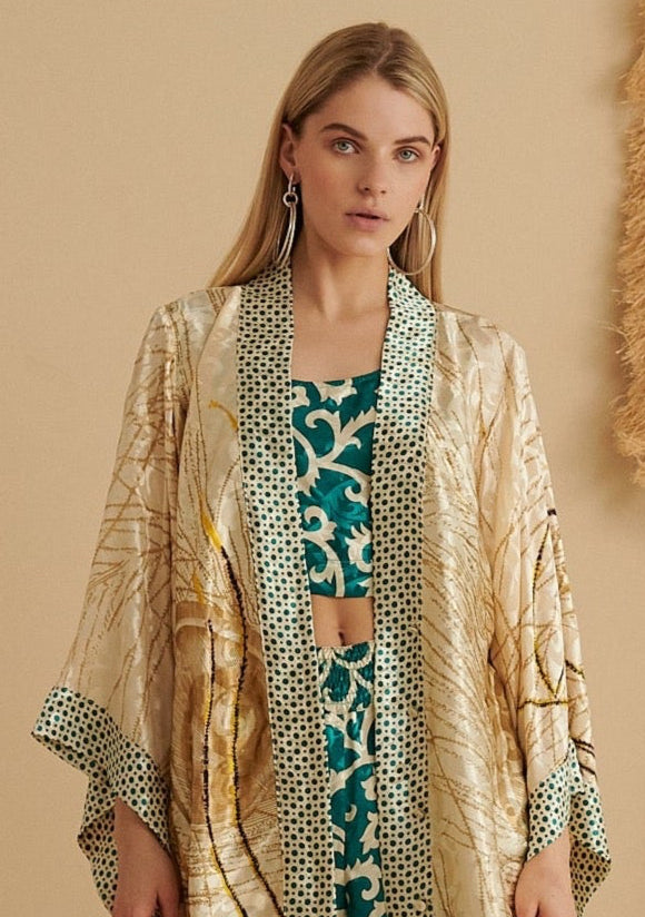 Sustainable handmade kimono in emerald green with golden peacock pattern and organic cotton trim, ethical fashion.