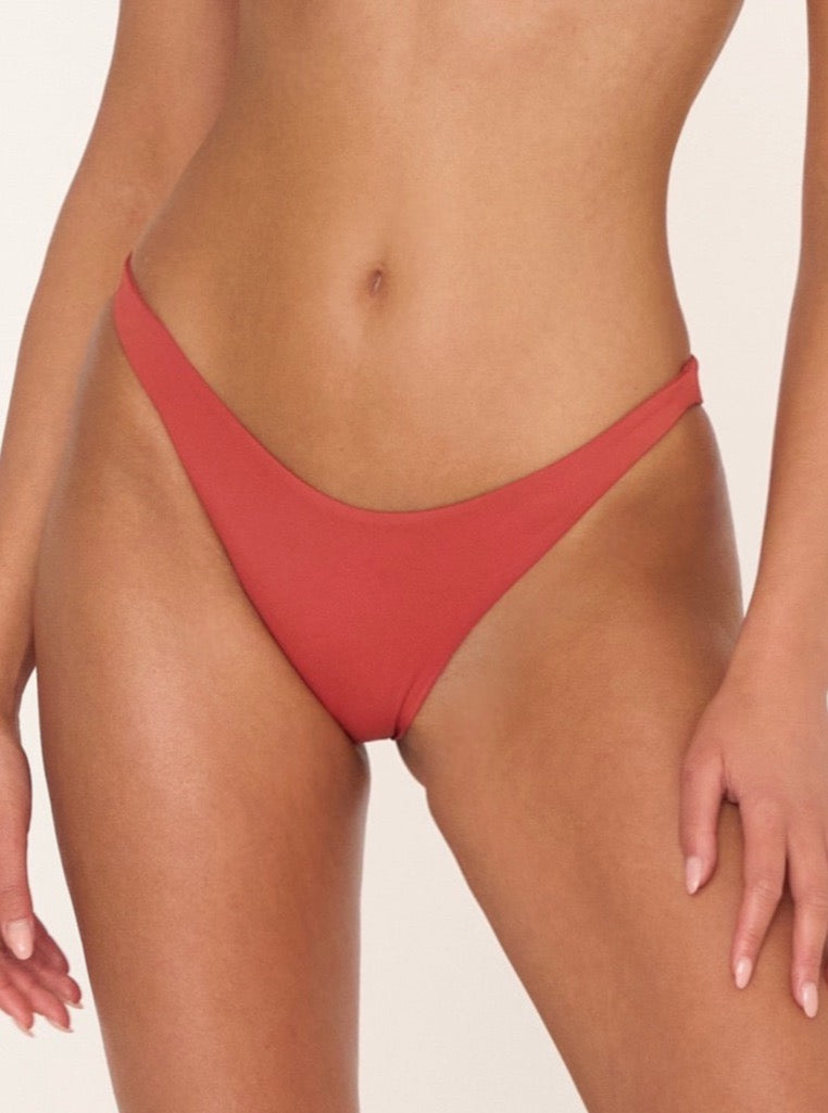 Rust red sustainable handmade bikini bottom with a high-cut design and eco-friendly organic fabric.