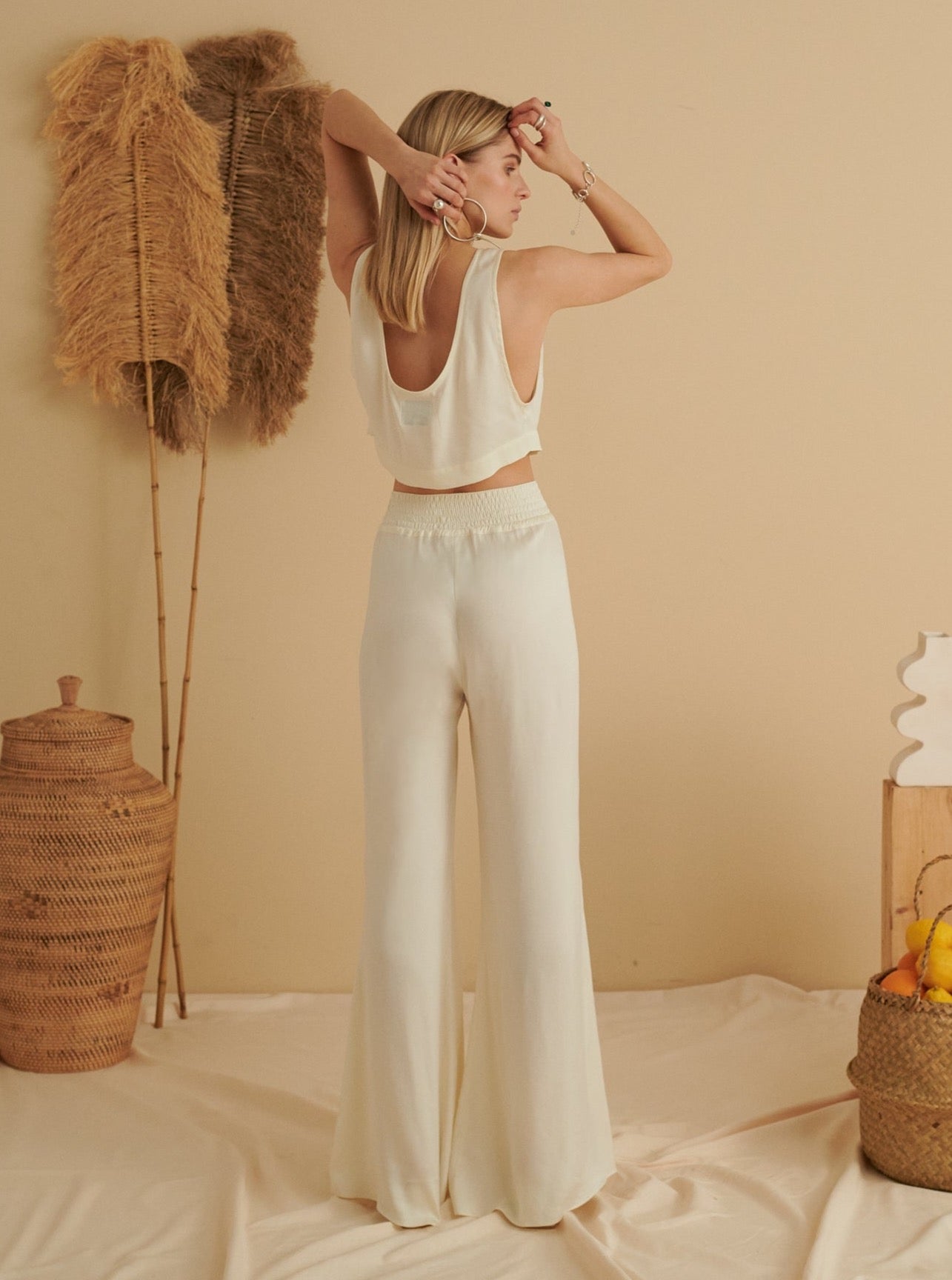 White dove flared cupro trousers with high waist and smooth drape, styled for sustainable, handmade, eco-friendly fashion.