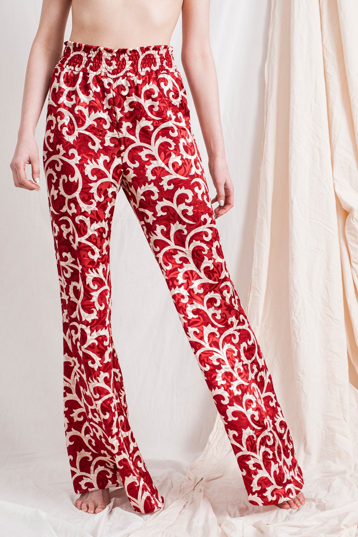 Red ruby flared trousers with bold white floral print, sustainable, handmade, eco-friendly organic fabric.
