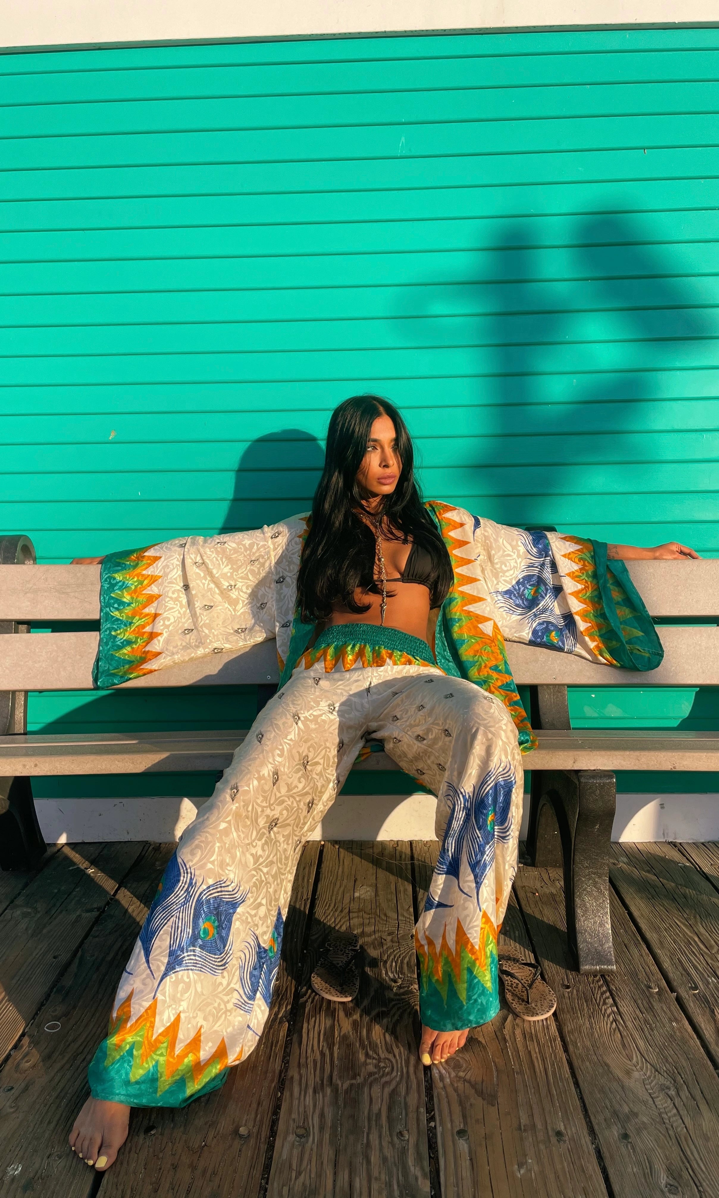 a woman bathing in the sun wearing emerald green summer silk set 